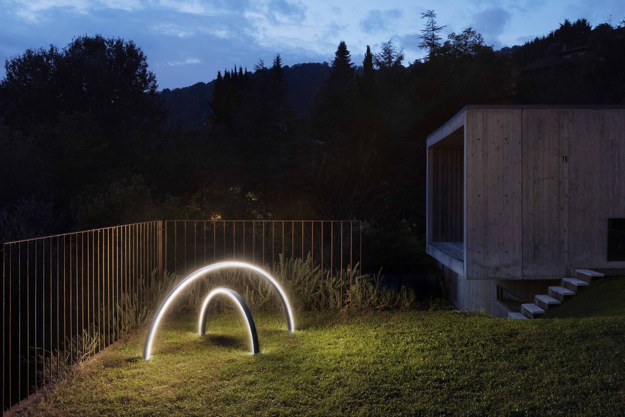 Zirkol Outdoor arcs on a lawn at dusk, wide view